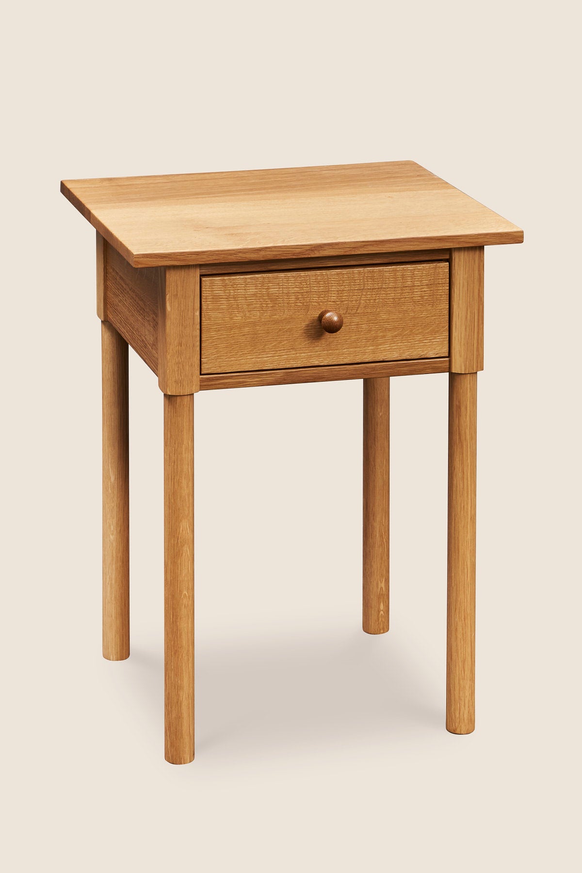 Modern interpretation of a classic Shaker style nightstand with one drawer and rounded legs, in solid white oak wood